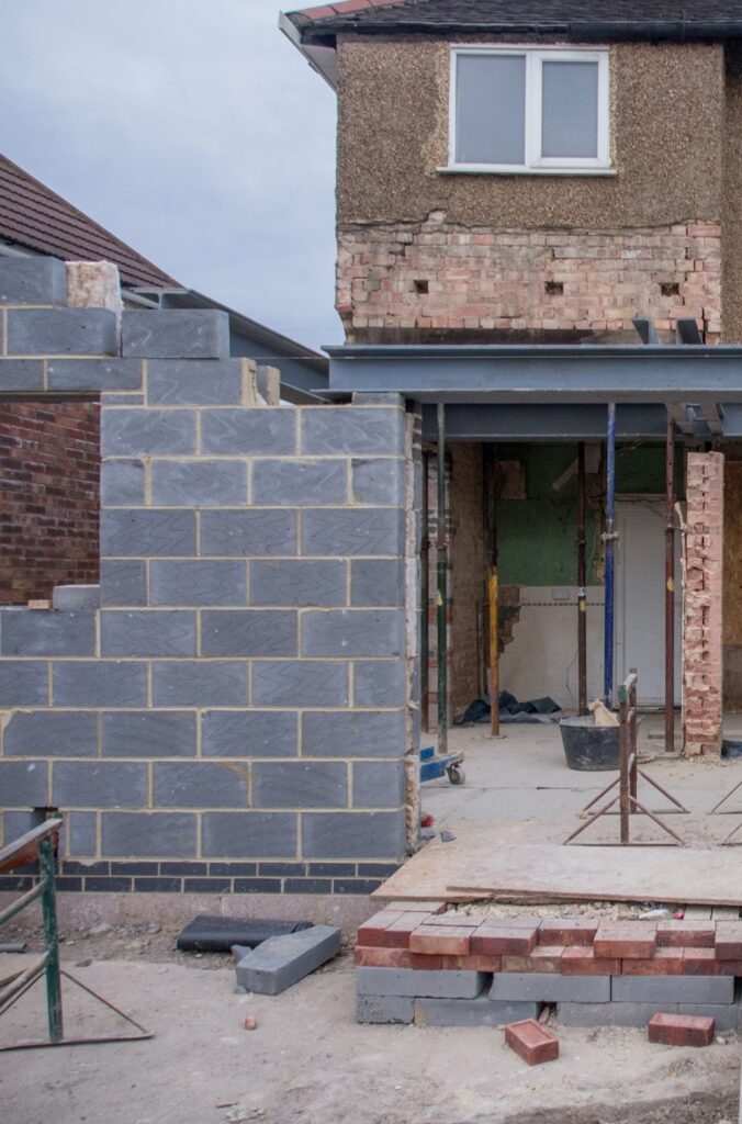 A partial image of a building extension job taking place with concrete blocks erected